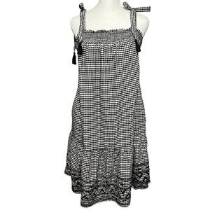 Classic and elegant black wrap dress featuring adjustable tie waist, ruffle hem,